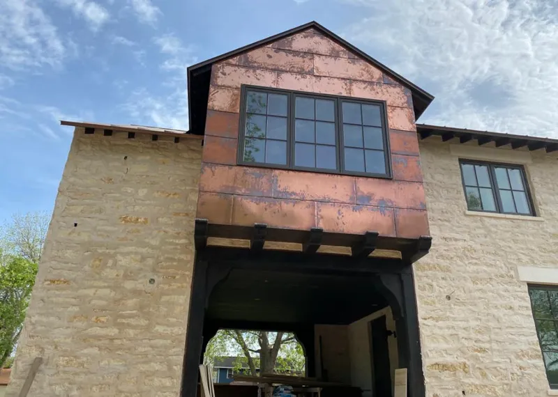 Copper metal panel facade on a stone building for Metal Roof Coating in Tamarac