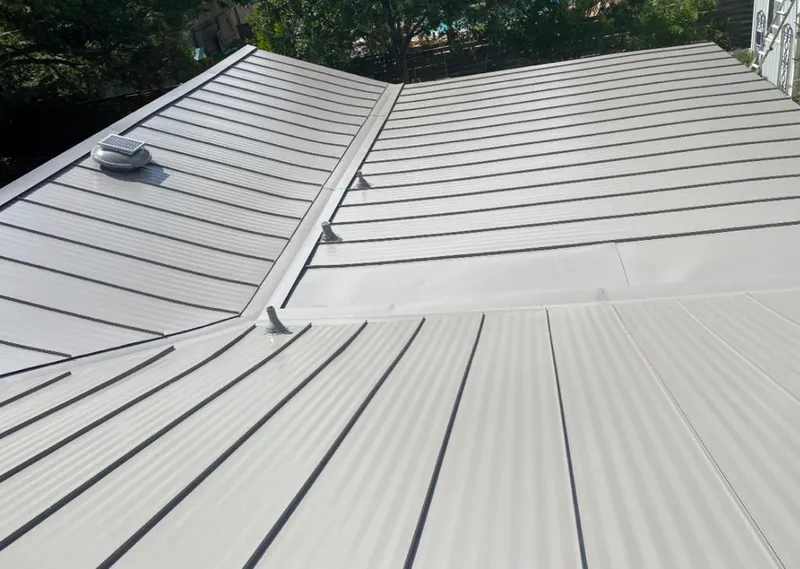 Solar attic fan installed on a metal roof for Roof Ventilation in Tamarac