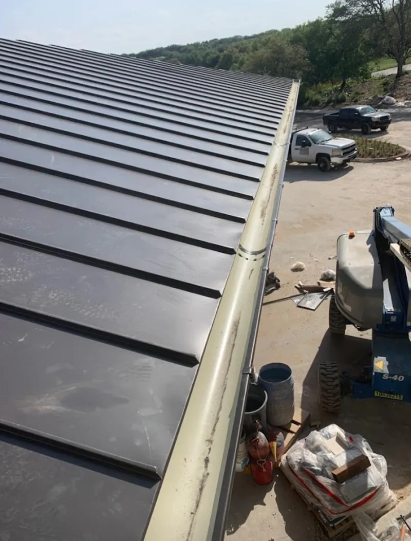Standing seam panel and gutter detail on a metal roofing jobsite in Tamarac